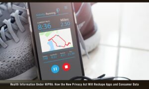 smartphone is leaning against a pair of running shoes.