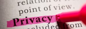 The word Privacy highlighted in pink on a page of text, with a pink marker nearby.